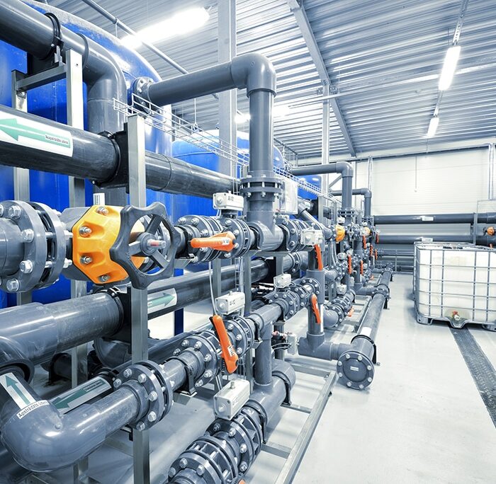 Technician servicing essential building plumbing infrastructure