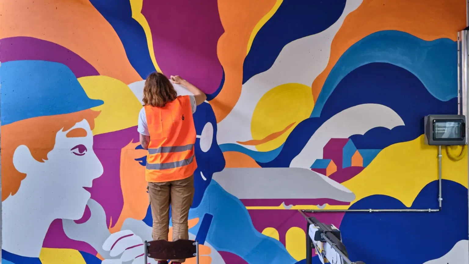 Painter applying a smooth finish coat to a commercial wall
