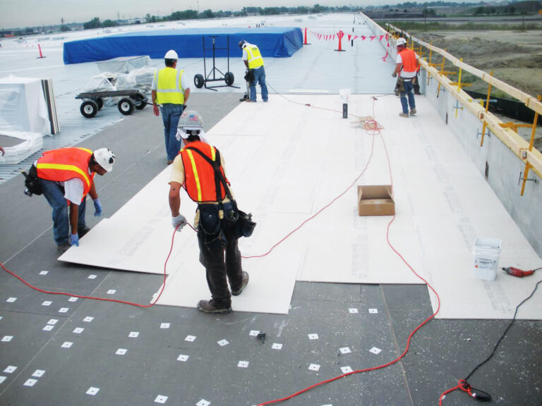 Worker repairing a large commercial building roof